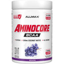 A white plastic tub of Allmax Aminocore BCAA powder in Grape flavor, featuring a white label with red and black text and a purple grape graphic.