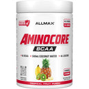 A white plastic tub of Allmax Aminocore BCAA dietary supplement in Tropical Fruit Punch flavor, featuring red and black text and fruit illustrations on the label.