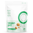 A white stand-up pouch of raw vegan pro Caramel au beurre + Buttercatch snack mix, featuring green text, a green circular graphic, and illustrations of caramel candies on a white background.