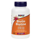 Bottle of NOW Foods Biotin (B-7) 10,000 mcg capsules with 120 Vcaps. The label is predominantly white with orange and green text and accents, and an image of a biotin molecule.
